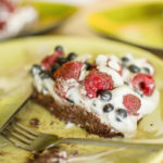 Raw vegan coconut chocolate cake with raspberries and blueberries